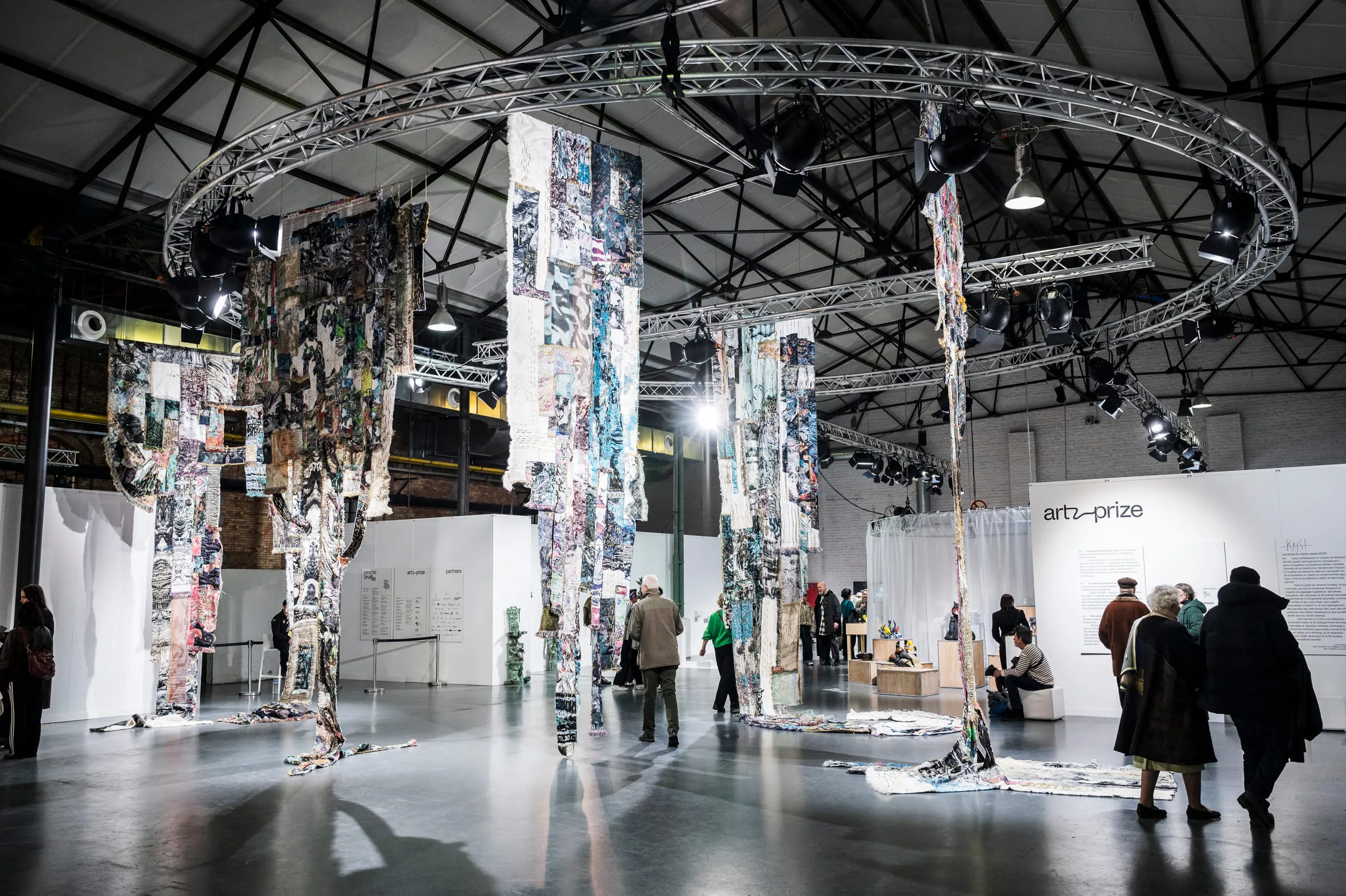 An installation of printed banners hung from a circular structure at the heart of the fair.